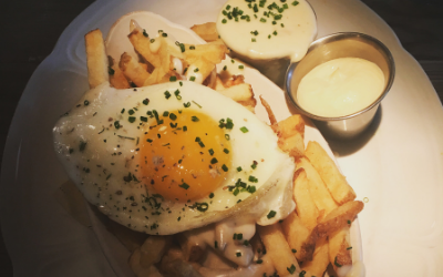 The crispy fries from Au Cheval with mornay sauce, garlic aioli & fried farm egg.
