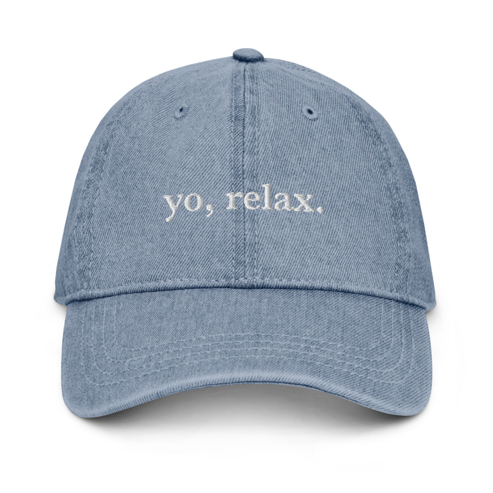 The ‘Yo Relax’ Denim Hat features six panels and an adjustable strap for a comfortable fit.